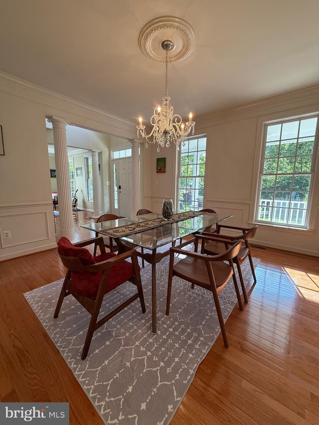 850 Still Creek Ln, Gaithersburg, MD 20878 - dining area featuring a decorative wall, ornamental molding, wood finished floors, decorative columns, and a chandelier