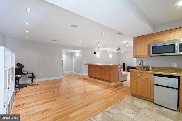 850 Still Creek Ln, Gaithersburg, MD 20878 - kitchen with stainless steel microwave, a sink, open floor plan, baseboards, and recessed lighting