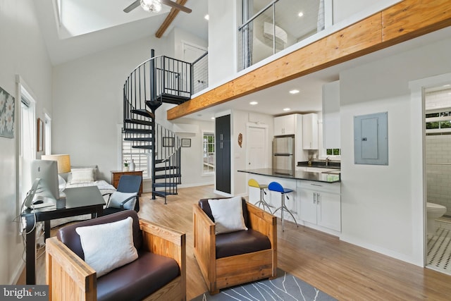 850 Still Creek Ln, Gaithersburg, MD 20878 - living room featuring high vaulted ceiling, light wood finished floors, stairs, electric panel, and a ceiling fan