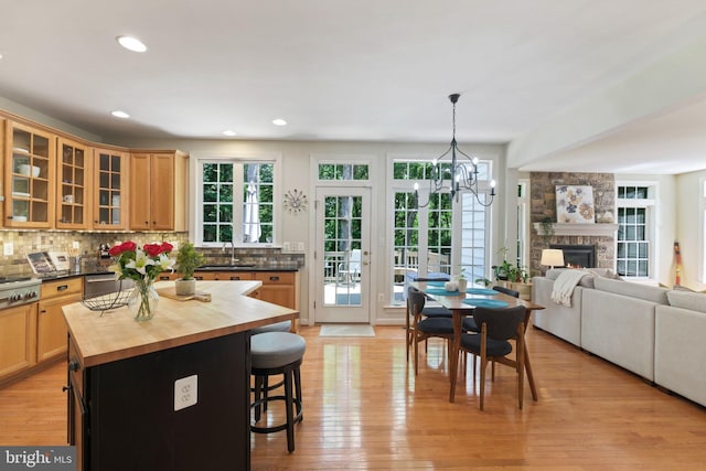 850 Still Creek Ln, Gaithersburg, MD 20878 - kitchen with wood counters, a sink, a breakfast bar, a chandelier, and backsplash
