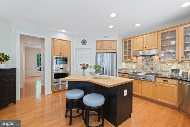 850 Still Creek Ln, Gaithersburg, MD 20878 - kitchen featuring appliances with stainless steel finishes, under cabinet range hood, wooden counters, a warming drawer, and a kitchen bar