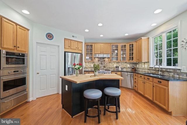 850 Still Creek Ln, Gaithersburg, MD 20878 - kitchen with appliances with stainless steel finishes, a sink, a warming drawer, butcher block counters, and a kitchen breakfast bar