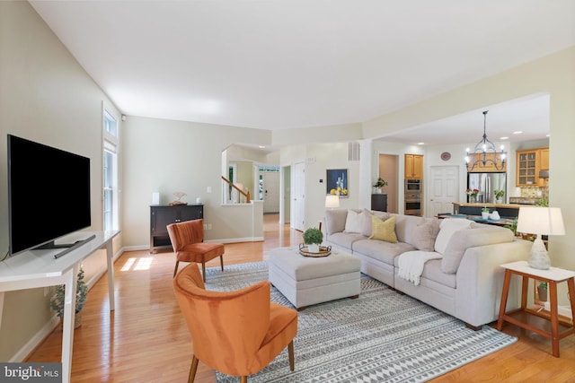 850 Still Creek Ln, Gaithersburg, MD 20878 - living room featuring light wood-type flooring, a chandelier, arched walkways, baseboards, and recessed lighting