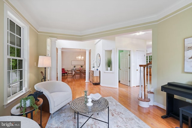 850 Still Creek Ln, Gaithersburg, MD 20878 - living area featuring ornate columns, wood finished floors, crown molding, a chandelier, and baseboards