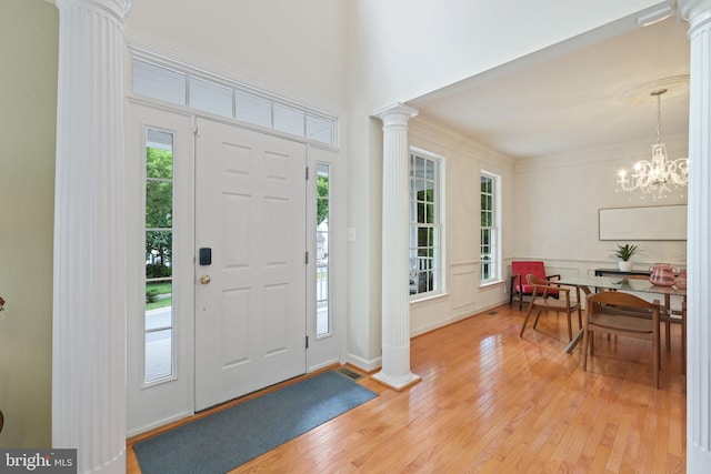 850 Still Creek Ln, Gaithersburg, MD 20878 - entryway with ornate columns, light wood finished floors, and a chandelier