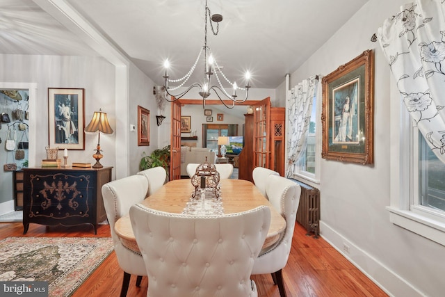 2 Broad St, Stockton, NJ 08559 - dining space with radiator heating unit, a chandelier, wood finished floors, and baseboards