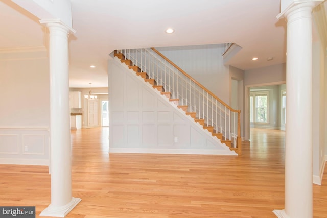 10709 Boswell Ln, Potomac, MD 20854 - entryway with decorative columns, healthy amount of natural light, light wood-style floors, a decorative wall, and recessed lighting