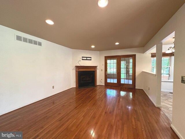 448 Country Club Dr, Lansdale, PA 19446 - unfurnished living room featuring hardwood / wood-style floors, a fireplace with flush hearth, recessed lighting, baseboards, and french doors