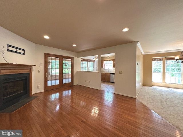 448 Country Club Dr, Lansdale, PA 19446 - unfurnished living room featuring baseboards, a fireplace with flush hearth, a chandelier, hardwood / wood-style floors, and recessed lighting