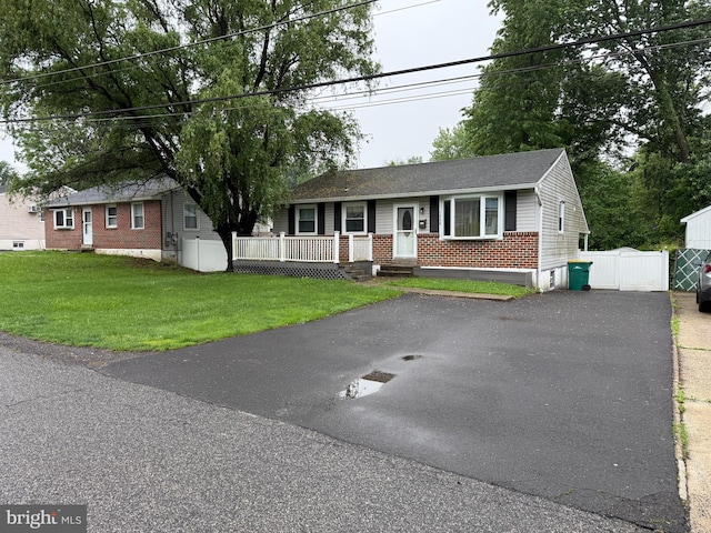 1236 Whittier Ave, Bensalem, PA 19020 - single story home with brick siding, asphalt driveway, a porch, and a front lawn