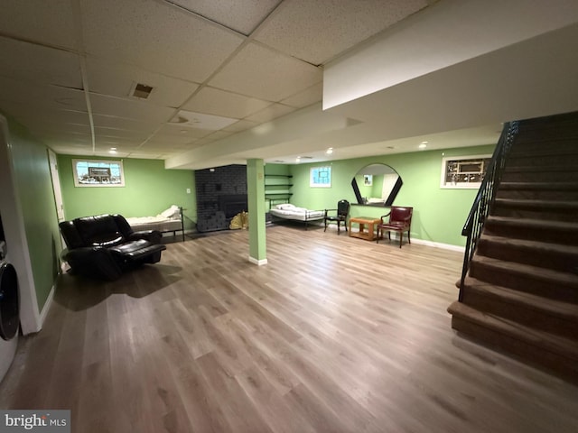 1236 Whittier Ave, Bensalem, PA 19020 - living room featuring baseboards, a drop ceiling, stairway, wood finished floors, and a brick fireplace