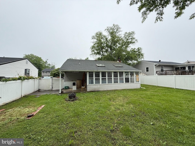 1236 Whittier Ave, Bensalem, PA 19020 - rear view of house featuring an outdoor fire pit, a sunroom, and a gate