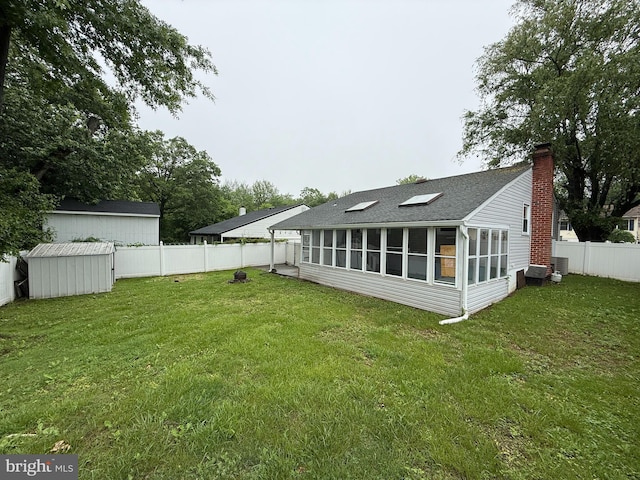 1236 Whittier Ave, Bensalem, PA 19020 - rear view of property with a sunroom, a shingled roof, a chimney, and central AC