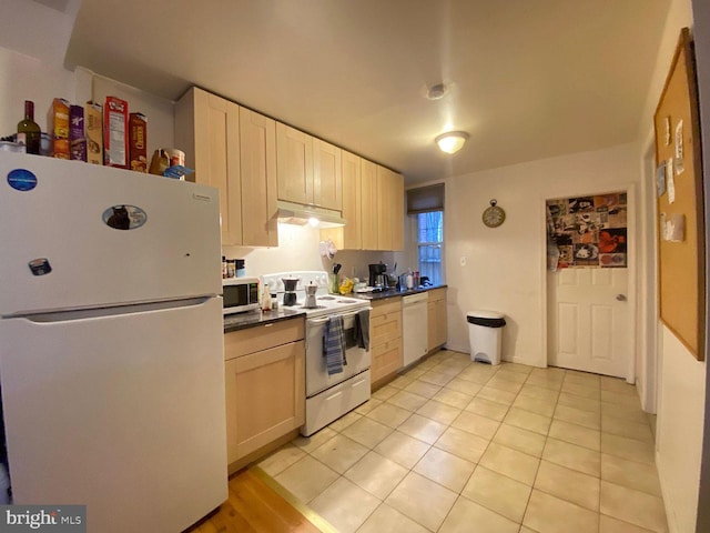 1527 Page St, Philadelphia, PA 19121 - kitchen with white appliances, under cabinet range hood, dark countertops, and light tile patterned floors