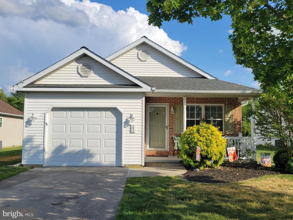231 Gaunt Dr, Mickleton, NJ 08056 - view of front of property featuring an attached garage, driveway, covered porch, brick siding, and a shingled roof