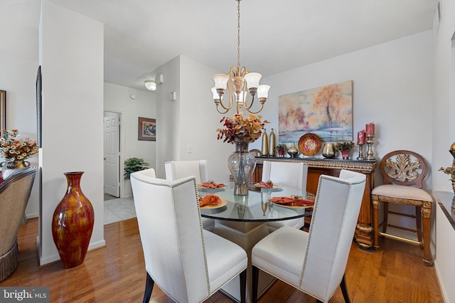 3100 N Leisure World Blvd Unit 716, Silver Spring, MD 20906 - dining room with wood finished floors, a chandelier, and baseboards