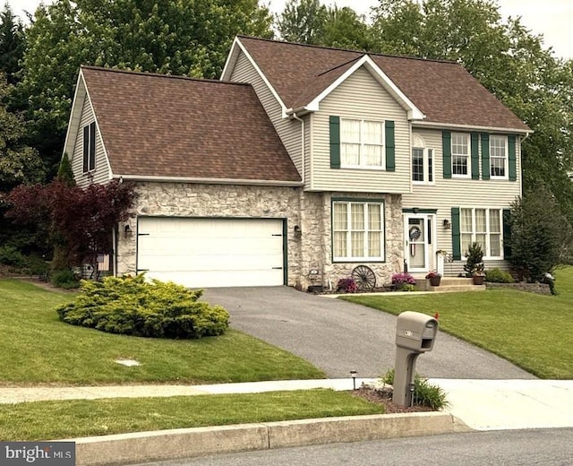 412 Hemlock Dr, New Cumberland, PA 17070 - view of front of house with stone siding, driveway, a front lawn, a shingled roof, and a garage