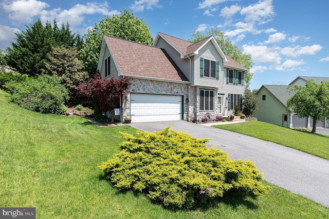 412 Hemlock Dr, New Cumberland, PA 17070 - view of front of property featuring stone siding, driveway, a front lawn, a shingled roof, and an attached garage