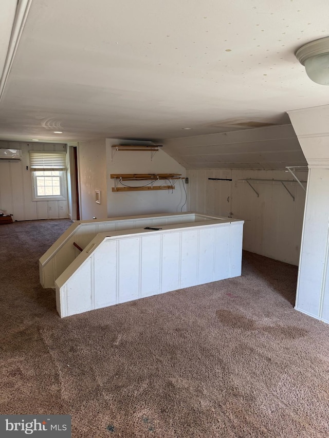 72 Maryland Ave, Crisfield, MD 21817 - kitchen with carpet flooring, a wall unit AC, lofted ceiling, and white cabinets