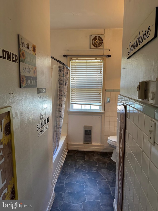72 Maryland Ave, Crisfield, MD 21817 - bathroom with toilet, heating unit, shower / bath combo, a wainscoted wall, and tile walls