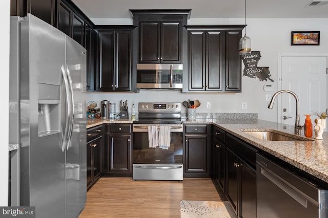 9629 Glassy Creek Way, Upper Marlboro, MD 20772 - kitchen with stainless steel appliances, a sink, light stone countertops, light wood-type flooring, and hanging light fixtures