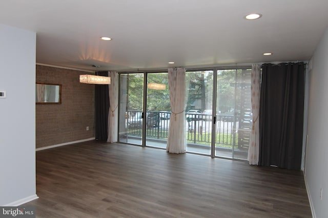4415 Briarwood Ct N Unit 11, Annandale, VA 22003 - unfurnished room featuring brick wall, baseboards, floor to ceiling windows, wood finished floors, and recessed lighting