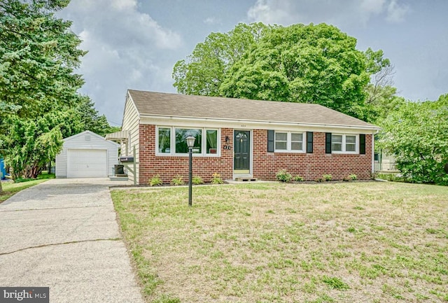 424 Sheridan Ave, Paulsboro, NJ 08066 - view of front of house with an outbuilding, brick siding, a garage, a front lawn, and driveway