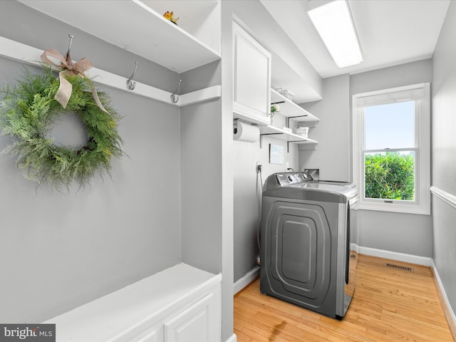 7100 Ewing Ct, Middletown, MD 21769 - laundry room with washer and clothes dryer and light wood-style flooring