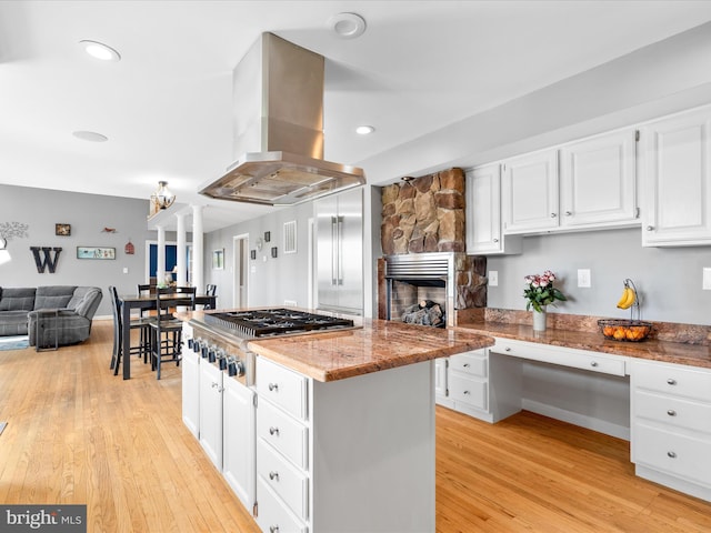 7100 Ewing Ct, Middletown, MD 21769 - kitchen with island exhaust hood, stainless steel gas stovetop, light wood-type flooring, white cabinetry, and recessed lighting