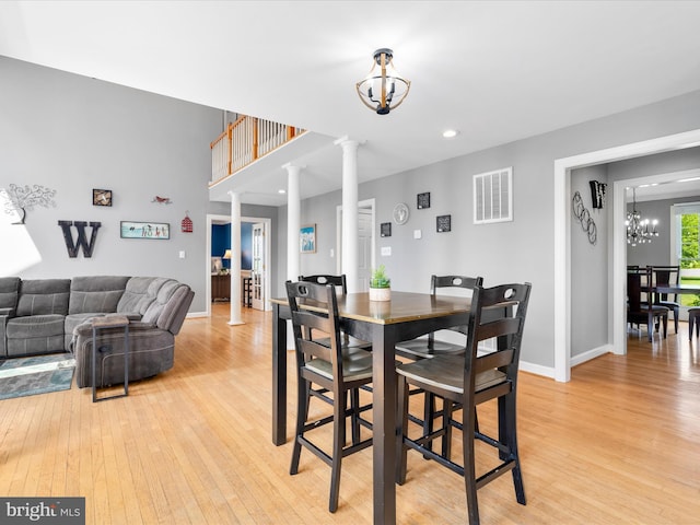 7100 Ewing Ct, Middletown, MD 21769 - dining room featuring a chandelier, decorative columns, light wood-style floors, and recessed lighting