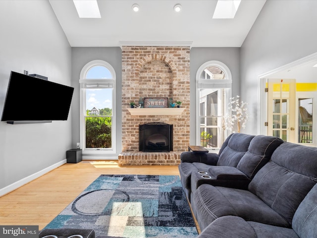 7100 Ewing Ct, Middletown, MD 21769 - living room featuring a skylight, wood finished floors, a fireplace, and high vaulted ceiling