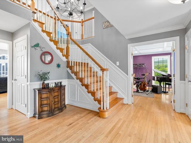 7100 Ewing Ct, Middletown, MD 21769 - entryway featuring ornamental molding, wood-type flooring, a decorative wall, stairway, and wainscoting
