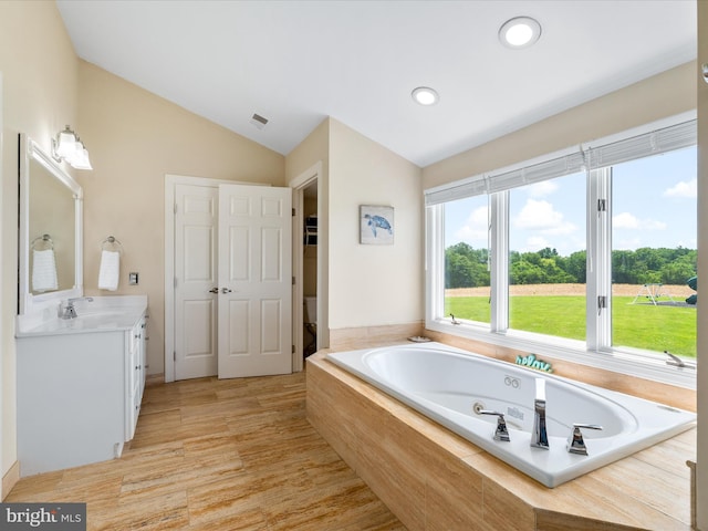 7100 Ewing Ct, Middletown, MD 21769 - full bathroom featuring vanity, lofted ceiling, a garden tub, and recessed lighting