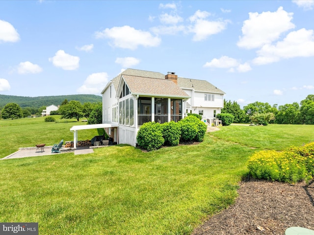 7100 Ewing Ct, Middletown, MD 21769 - back of house featuring a sunroom, a yard, a patio, and a chimney