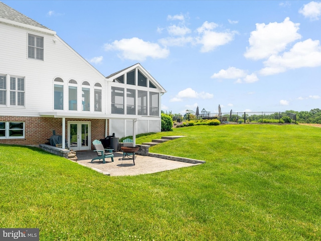 7100 Ewing Ct, Middletown, MD 21769 - rear view of property featuring french doors, a sunroom, a patio, and brick siding
