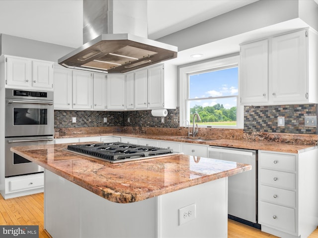 7100 Ewing Ct, Middletown, MD 21769 - kitchen with appliances with stainless steel finishes, island exhaust hood, a center island, and light stone countertops