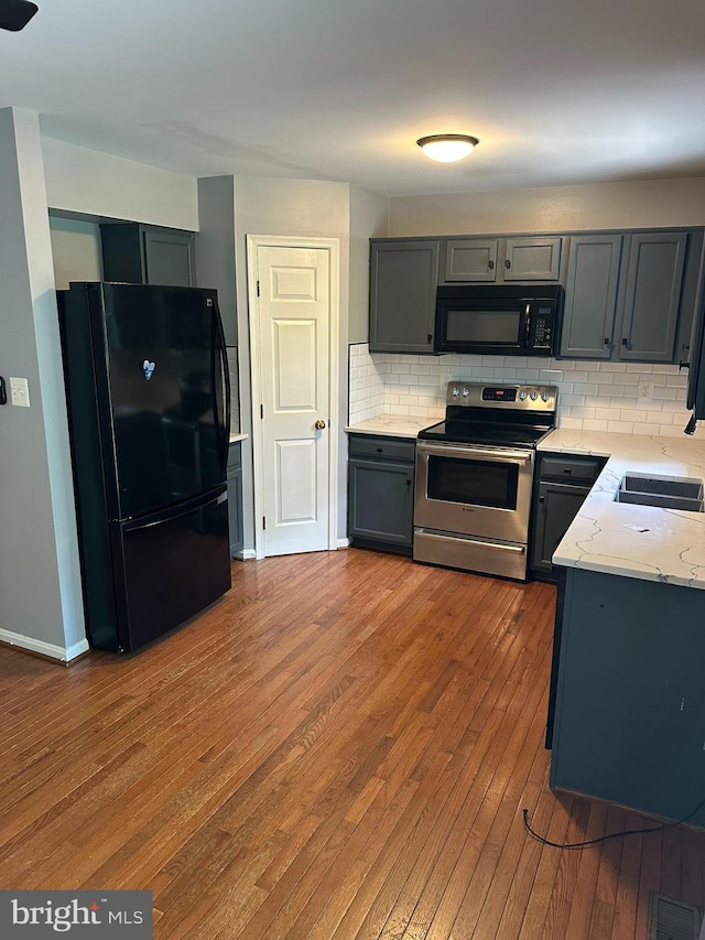 14208 Creekbranch Way, Gainesville, VA 20155 - kitchen with black appliances, a sink, backsplash, hardwood / wood-style flooring, and gray cabinetry