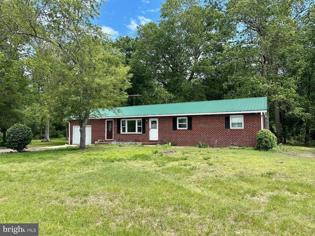 16932 Diggins Rd, Henderson, MD 21640 - view of front facade featuring an attached garage, a front yard, entry steps, brick siding, and metal roof