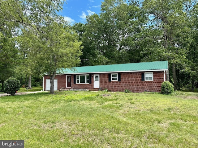16932 Diggins Rd, Henderson, MD 21640 - view of front facade featuring an attached garage, a front yard, entry steps, brick siding, and metal roof