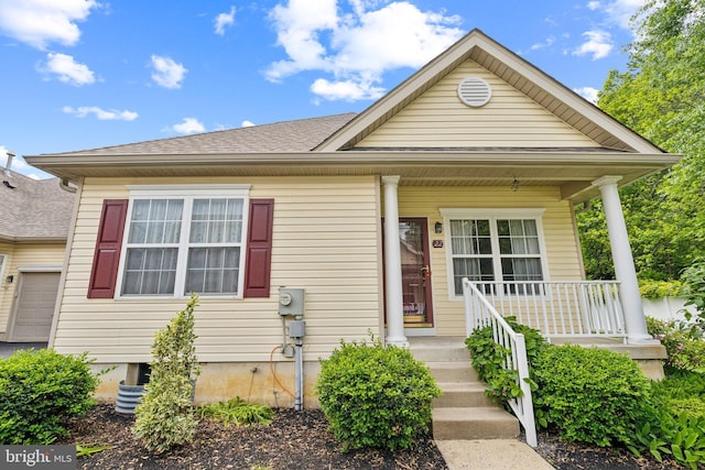 22 Regents Ct, Bensalem, PA 19020 - view of front of home featuring covered porch and roof with shingles