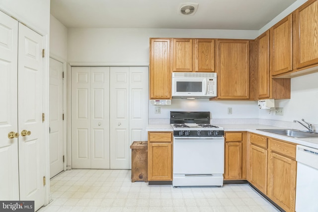 22 Regents Ct, Bensalem, PA 19020 - kitchen with white appliances, a sink, light flooring, and light countertops