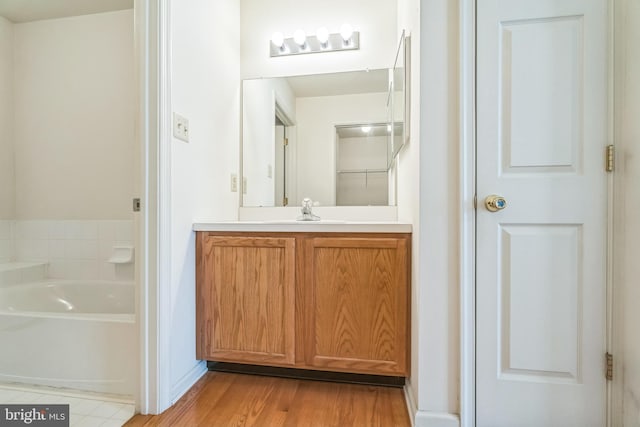 22 Regents Ct, Bensalem, PA 19020 - bathroom with a garden tub, vanity, and wood finished floors