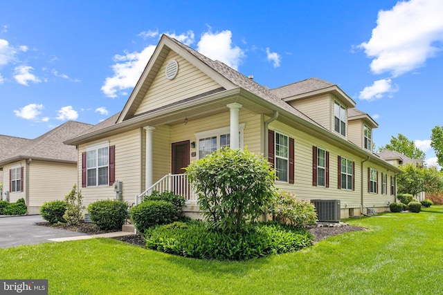 22 Regents Ct, Bensalem, PA 19020 - view of front of home with a front lawn, a shingled roof, and central air condition unit