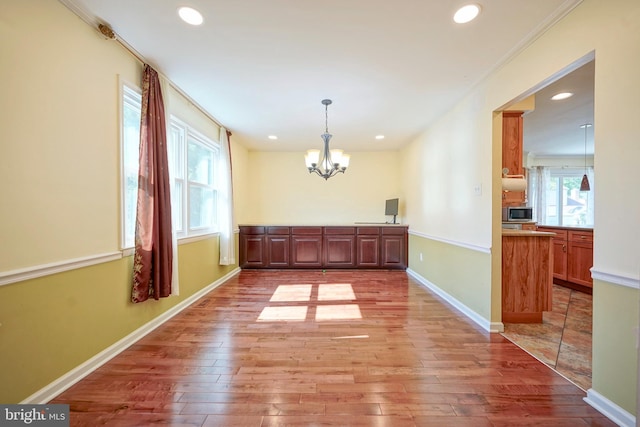 30 Lancelot Ln, Mount Laurel, NJ 08054 - unfurnished dining area with light wood-style floors, a chandelier, recessed lighting, baseboards, and crown molding