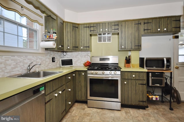 812 Jenkintown Rd, Elkins Park, PA 19027 - kitchen with appliances with stainless steel finishes, a sink, tasteful backsplash, and light countertops