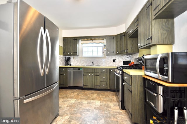 812 Jenkintown Rd, Elkins Park, PA 19027 - kitchen with appliances with stainless steel finishes, a sink, tasteful backsplash, and light countertops