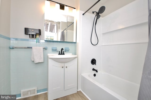 812 Jenkintown Rd, Elkins Park, PA 19027 - bathroom with tile walls, vanity, shower / tub combo, wood finished floors, and a wainscoted wall