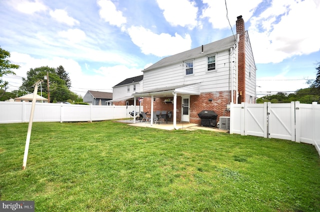 812 Jenkintown Rd, Elkins Park, PA 19027 - back of property with a gate, brick siding, a patio area, a chimney, and central air condition unit