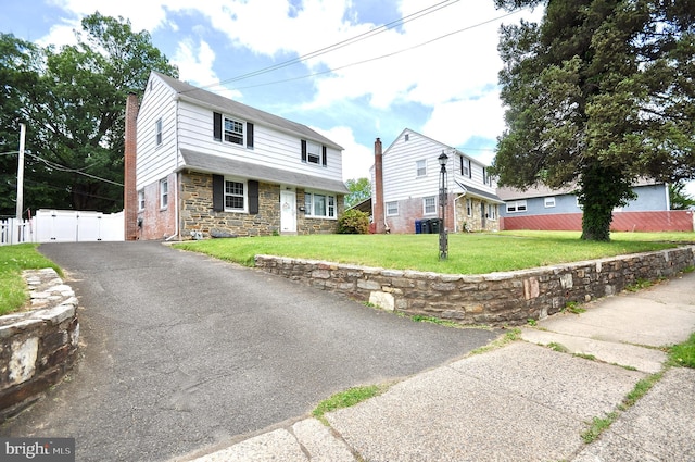 812 Jenkintown Rd, Elkins Park, PA 19027 - view of front facade featuring a gate, stone siding, driveway, a chimney, and cooling unit