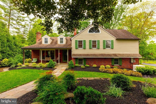 410 Heatherwood Ln, Devon, PA 19333 - tri-level home with a porch, brick siding, a chimney, and a front lawn